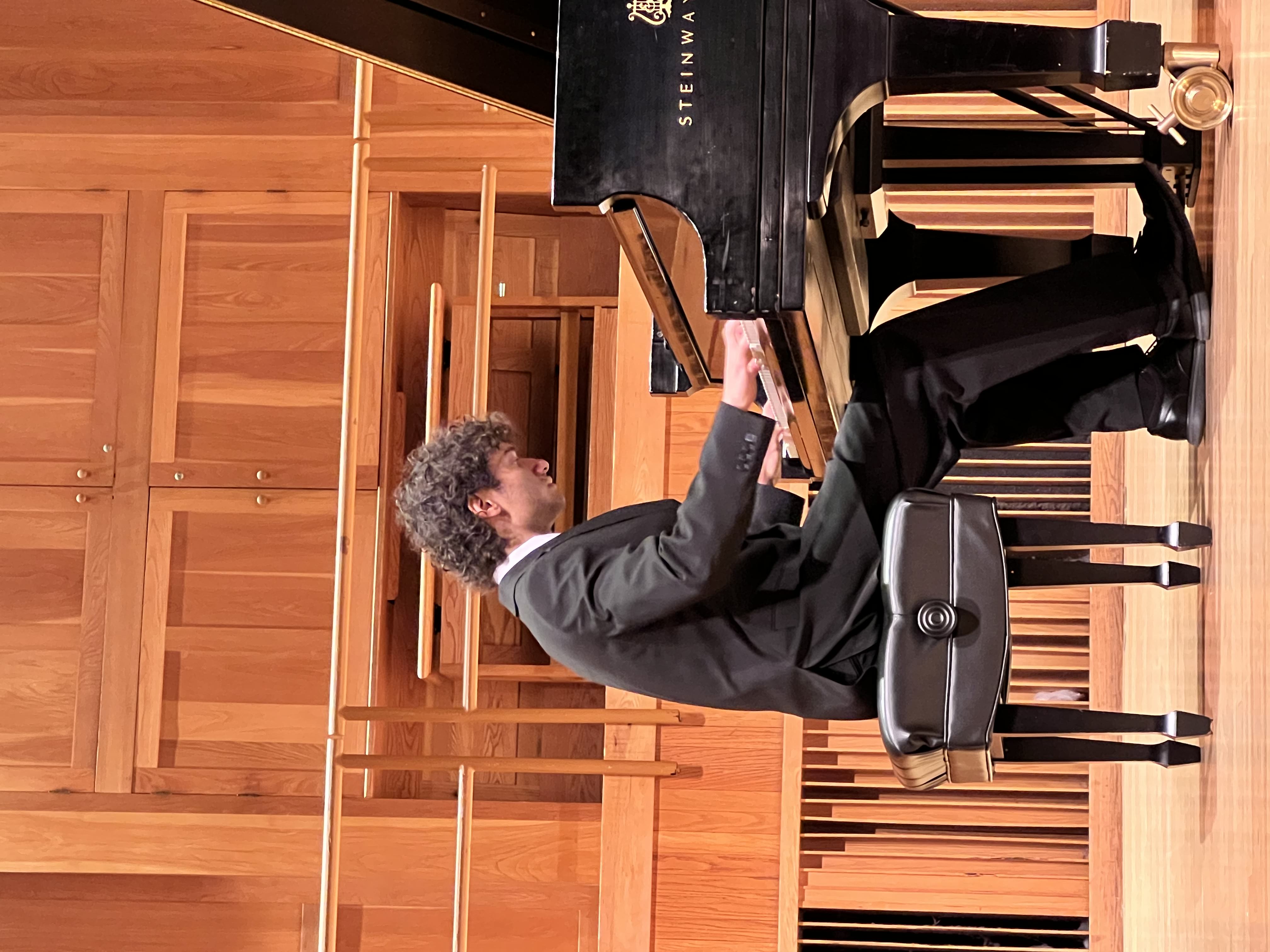 Oliver Rivera performing at a grand piano